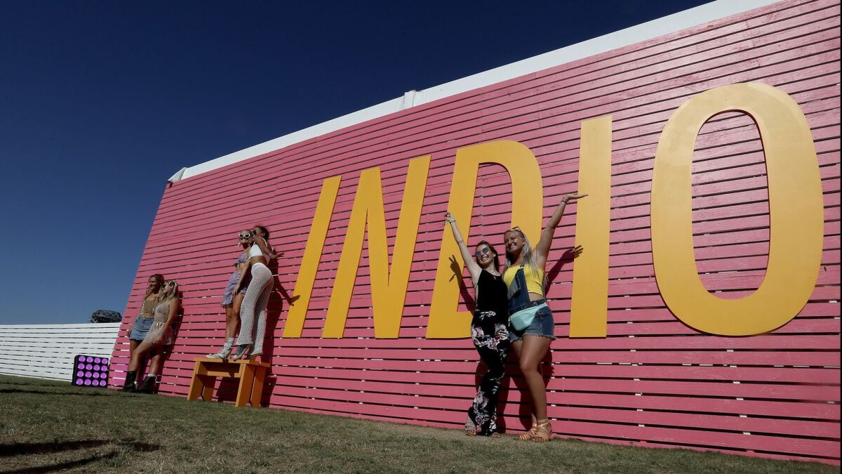 Festival-goers pose outside of Coachella's Indio Central Market on a hot 2018 afternoon.