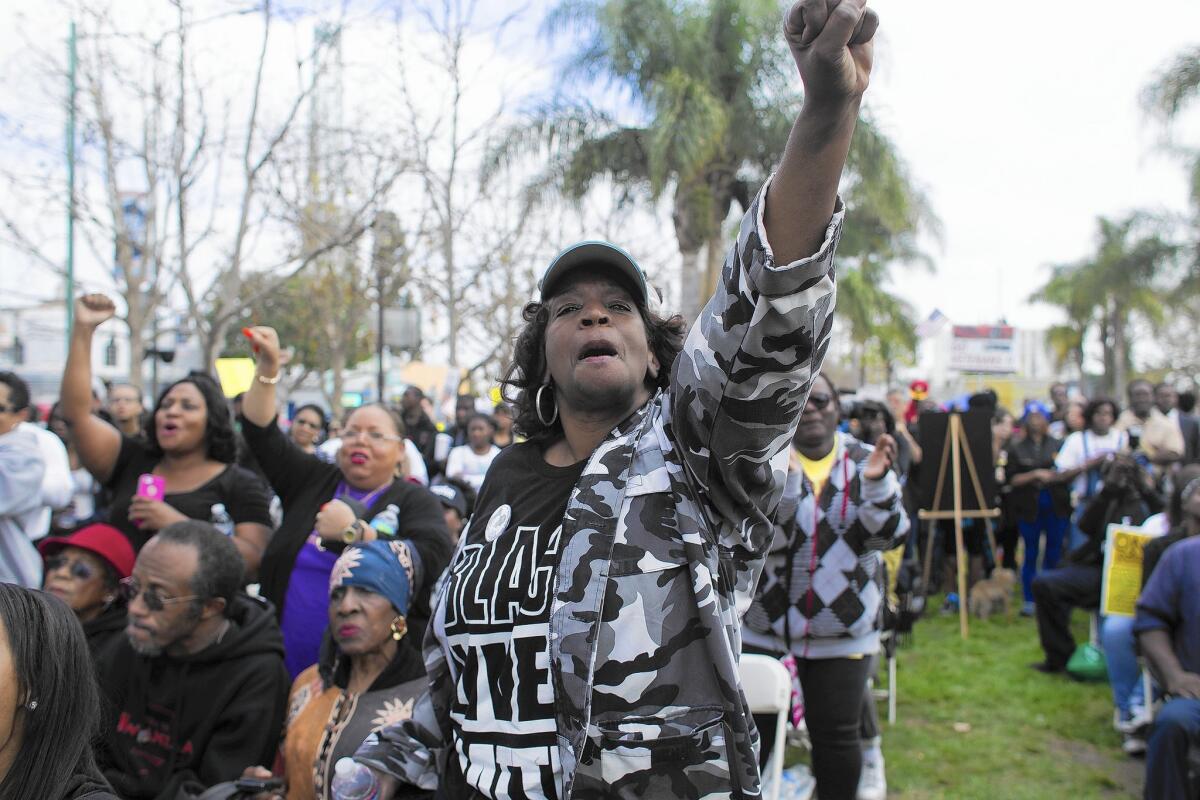 Linda Jay joins hundreds of protesters to rally against police abuse and to remember Ezell Ford, a mentally ill black man killed by LAPD officers, in Leimert Park on Saturday.