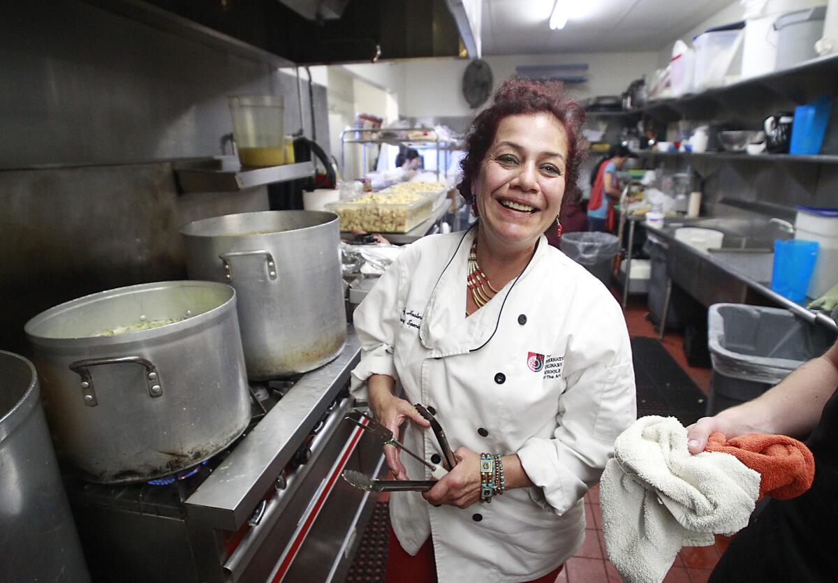 Chef Lorrie Sanchez steps into her role as the official turkey cook for the Thanksgiving dinner at the Someone Cares Soup Kitchen in Costa Mesa on Wednesday. Sanchez will cook four turkeys at one time that will feed hundreds of people who count on a Thanksgiving dinner.