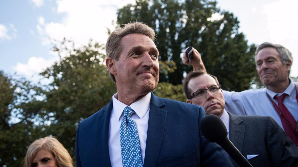 Sen. Jeff Flake (R-AZ) and his wife Cheryl Flake leave the U.S. Capitol as they are trailed by reporters on Oct. 24, 2017, in Washington, D.C. Flake announced he will not be seeking reelection and he will leave the Senate after his term ends in 14 months.