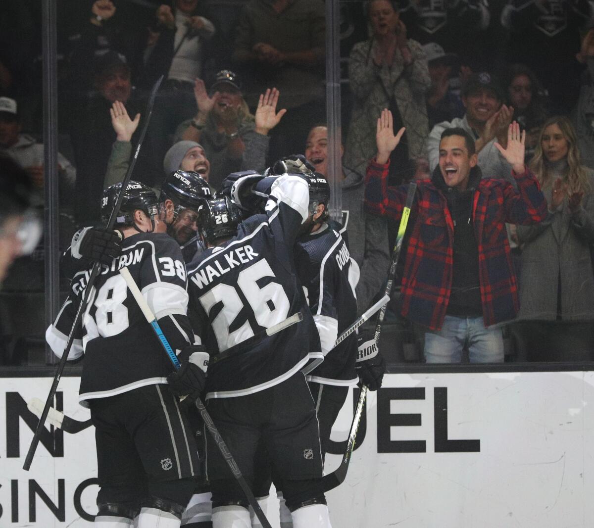 Kings center Tyler Toffoli (73) is surrounded by his teammates after scoring a goal against the Oilers during the first period of a game Nov. 21 at Staples Center.