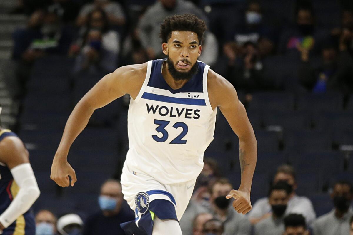 Minnesota Timberwolves center Karl-Anthony Towns reacts after dunking against the New Orleans Pelicans in the first half of an NBA preseason basketball game, Monday, Oct. 4, 2021, in Minneapolis. (AP Photo/Andy Clayton-King)