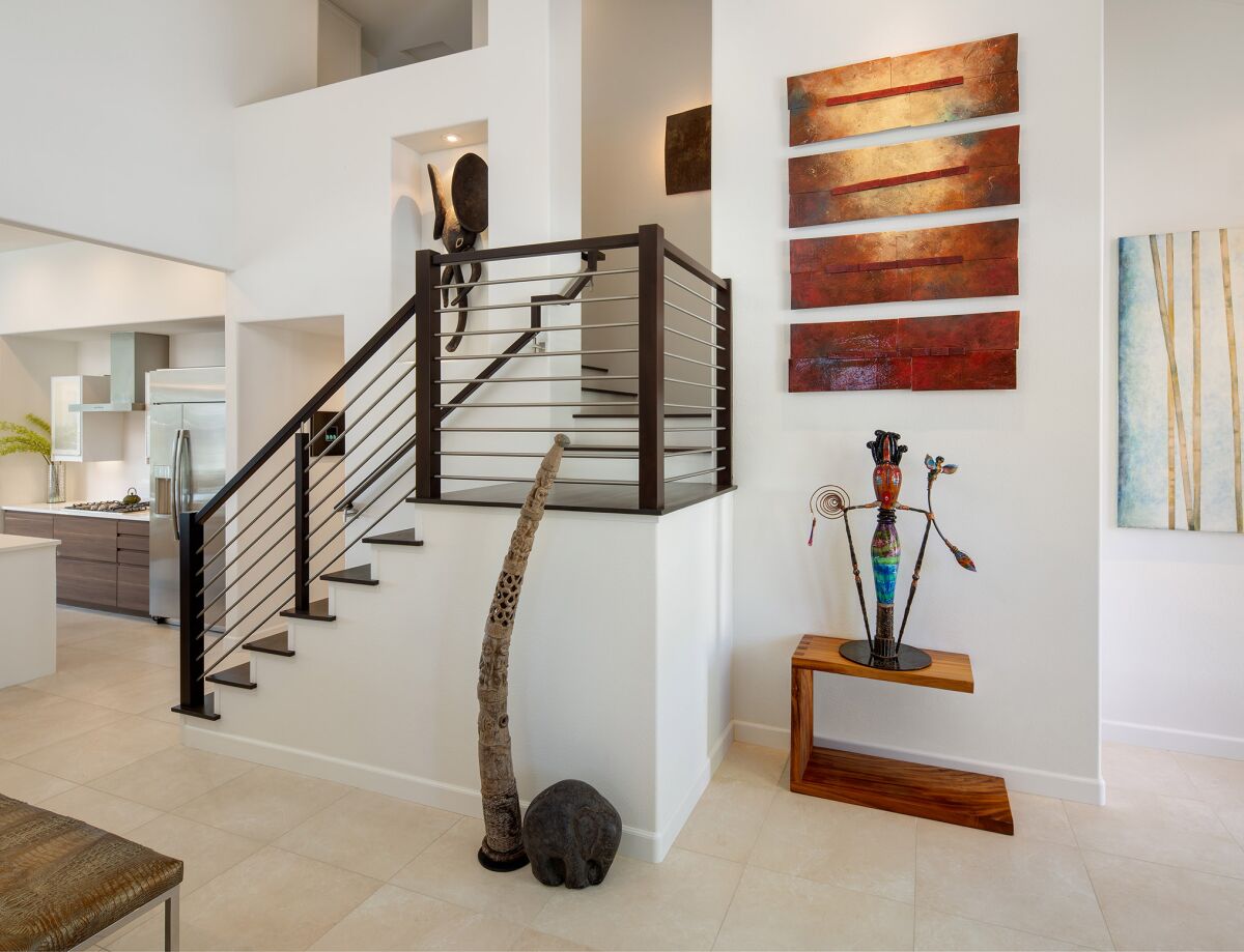 The remodel squared off the rounded edges of the landing on the stairs to create a contemporary look.