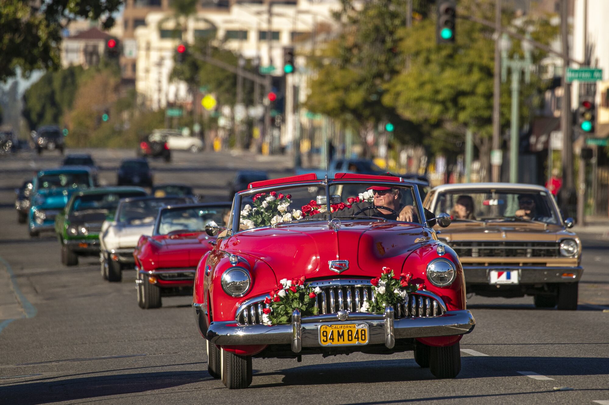 Classic cars with Sultans Car Club of Long Beach drive the Rose Parade route in Pasadena.