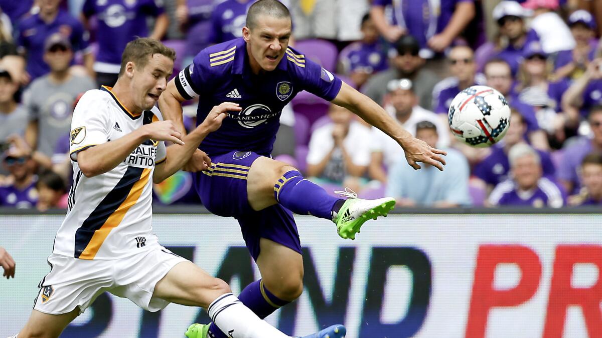 Galaxy defender Nathan Smith arrives too late to prevent Orlando City's Will Johnson from scoring during the first half Saturday.
