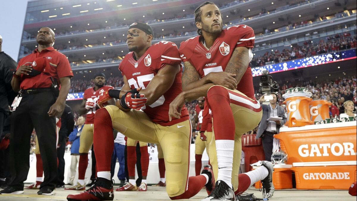 In this Sept. 12, 2016, file photo, San Francisco 49ers safety Eric Reid and quarterback Colin Kaepernick kneel during the national anthem before an NFL football game.