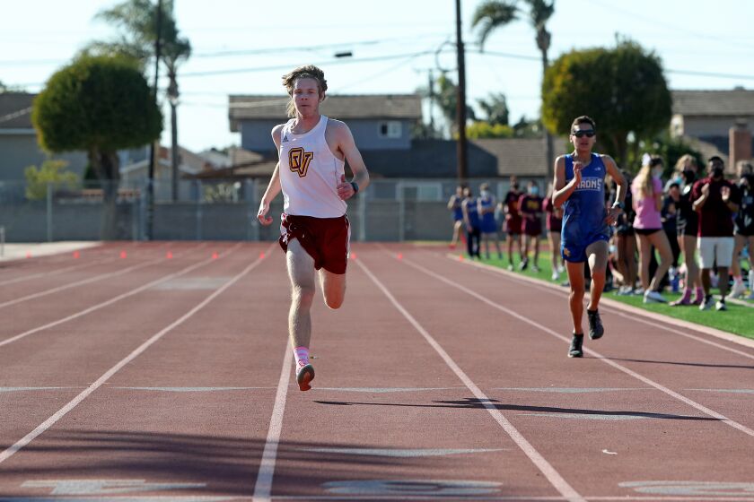 Ocean View's Parker Walpole beats Fountain Valley's Benjamin Pardo to the finish line for third place during the Huntington Beach Union High School District cross-country dual meet at Fountain Valley High School on Saturday.