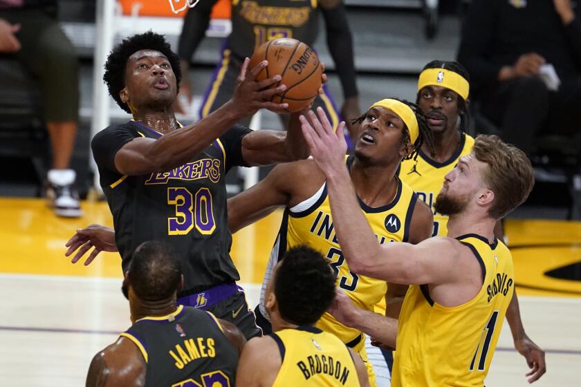 Los Angeles Lakers center Damian Jones (30) drives to the basket against the Indiana Pacers during the first half of an NBA basketball game Friday, March 12, 2021, in Los Angeles. (AP Photo/Marcio Jose Sanchez)