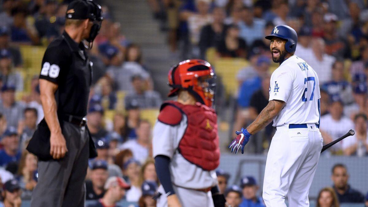 Dodgers outfielder Matt Kemp argues a strikeout looking call with umpire Jim Wolf between St. Louis Cardinals catcher Yadier Molina during the sixth inning at Dodger Stadium on Tuesday.