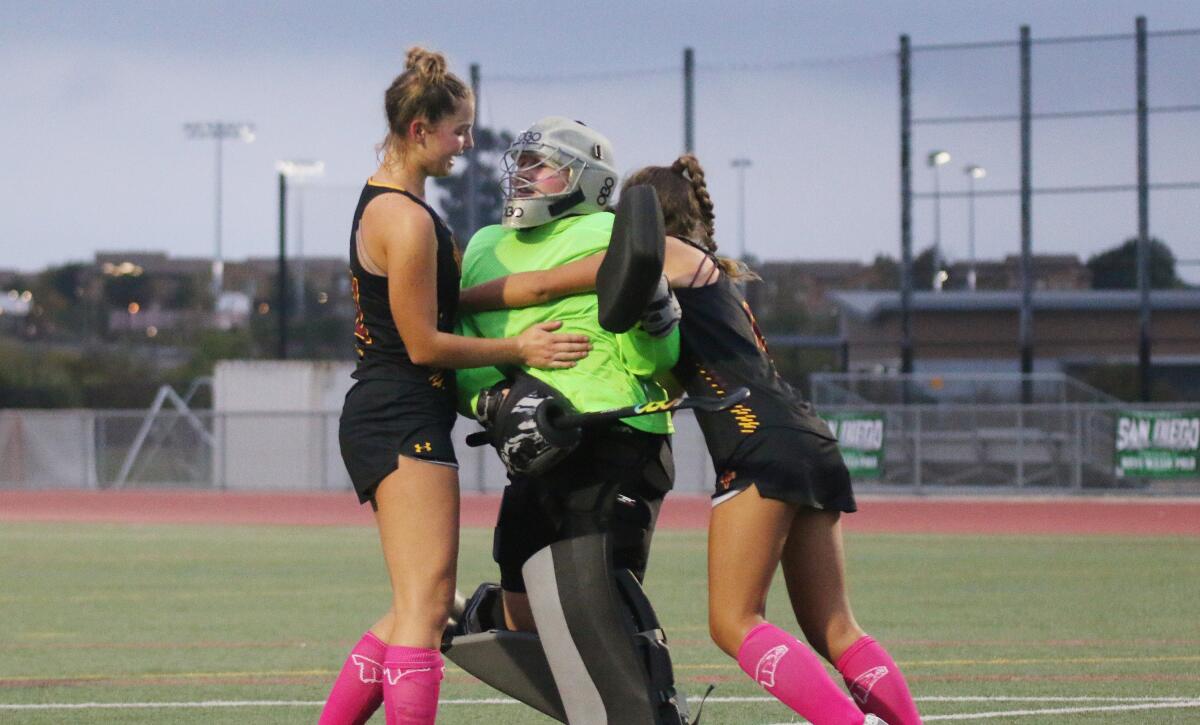 Falcon goalie Bella Anfuso celebrates with teammates.