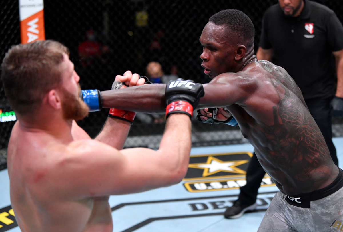 Israel Adesanya, right, punches Jan Blachowicz during their light heavyweight championship fight at UFC 259.