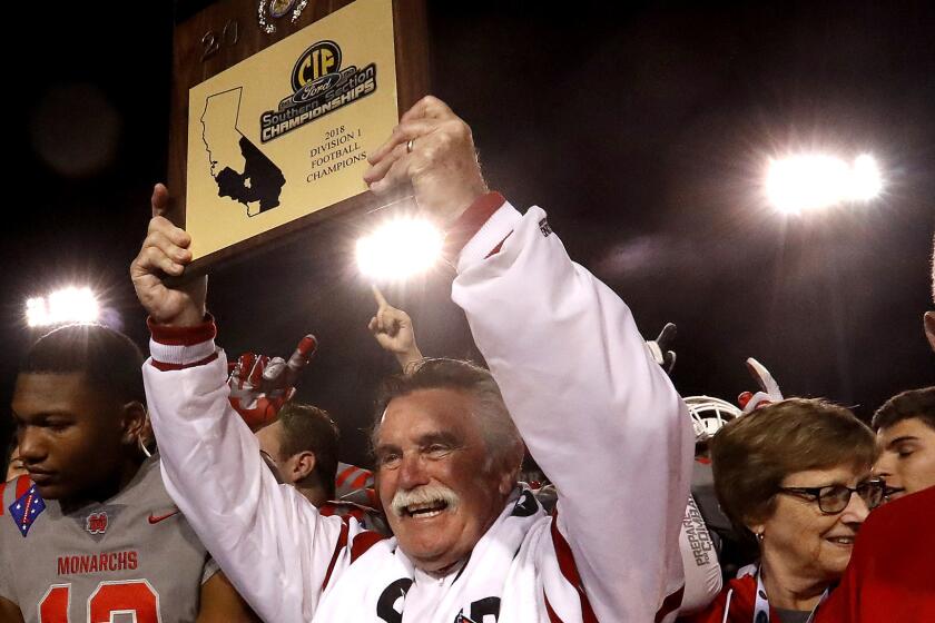 CERRITOS, CALIF. .. - NOV. 23, 2018. Mater Dei head coach Bruce Rollinsonholds up tghe CIF Championship plaque after the Monarchs defeated St. John Bopsco on Friday night, Nov. 23, 2018, at Cerritos College. (Luis Sinco/Los Angeles Times)