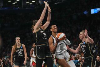 Las Vegas Aces' A'ja Wilson (22) drives to the basket as New York Liberty's Stefanie Dolson (31) and Courtney Vandersloot (22) defends during the first half in Game 4 of a WNBA basketball final playoff series Wednesday, Oct. 18, 2023, in New York. (AP Photo/Frank Franklin II)