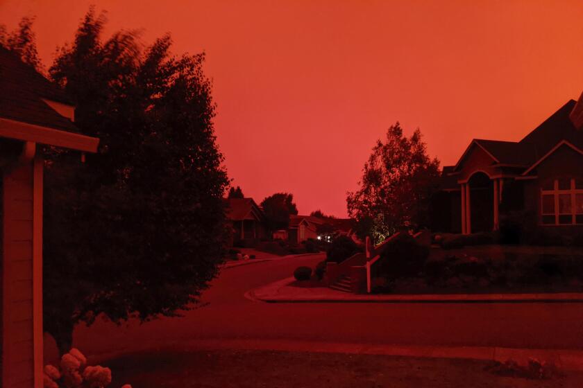 This photo taken from the home of Russ Casler in Salem, Ore., shows the smoke-darkened sky well before sunset, around 5 p.m., Tuesday, Sept. 8, 2020. Strong winds and high temperatures continued to fuel catastrophic fires in many parts of Oregon on Wednesday, forcing thousands of people to flee from their homes and making for poor air quality throughout the West. Huge wildfires also continued to grow in neighboring Washington state. (Russ Casler via AP)