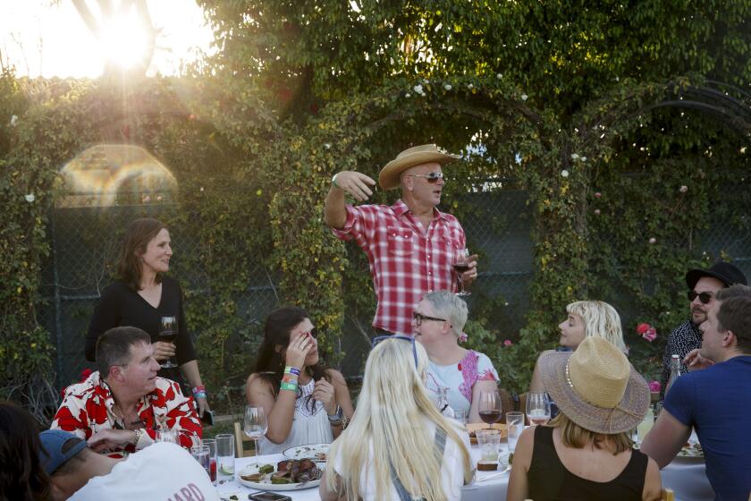 Jim Denevan, founder of Outstanding in the Field, speaks to guests of the table dinner during weekend one of the three-day Coachella Valley Music and Arts Festival at the Empire Polo Grounds on Friday, April 14, 2017 in Indio, Calif. A wide assortment of Los Angeles restaurants and chefs are providing unique food and crafted drink options for the festival. (Patrick T. Fallon/ For The Los Angeles Times)