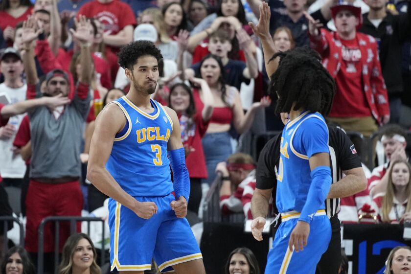 UCLA's Johnny Juzang (3) celebrates after a play against Arizona during the first half.