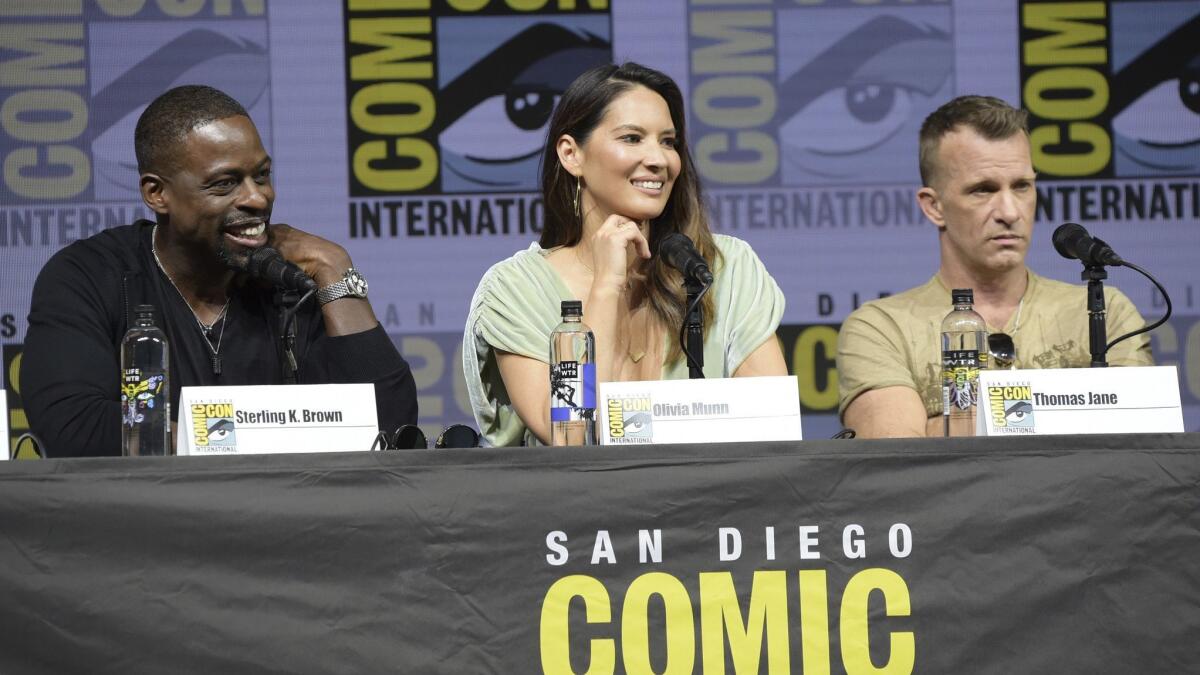Sterling K. Brown, left, Olivia Munn and Thomas Jane attend the 20th Century Fox "Predator" panel on Day one of Comic-Con International in San Diego.