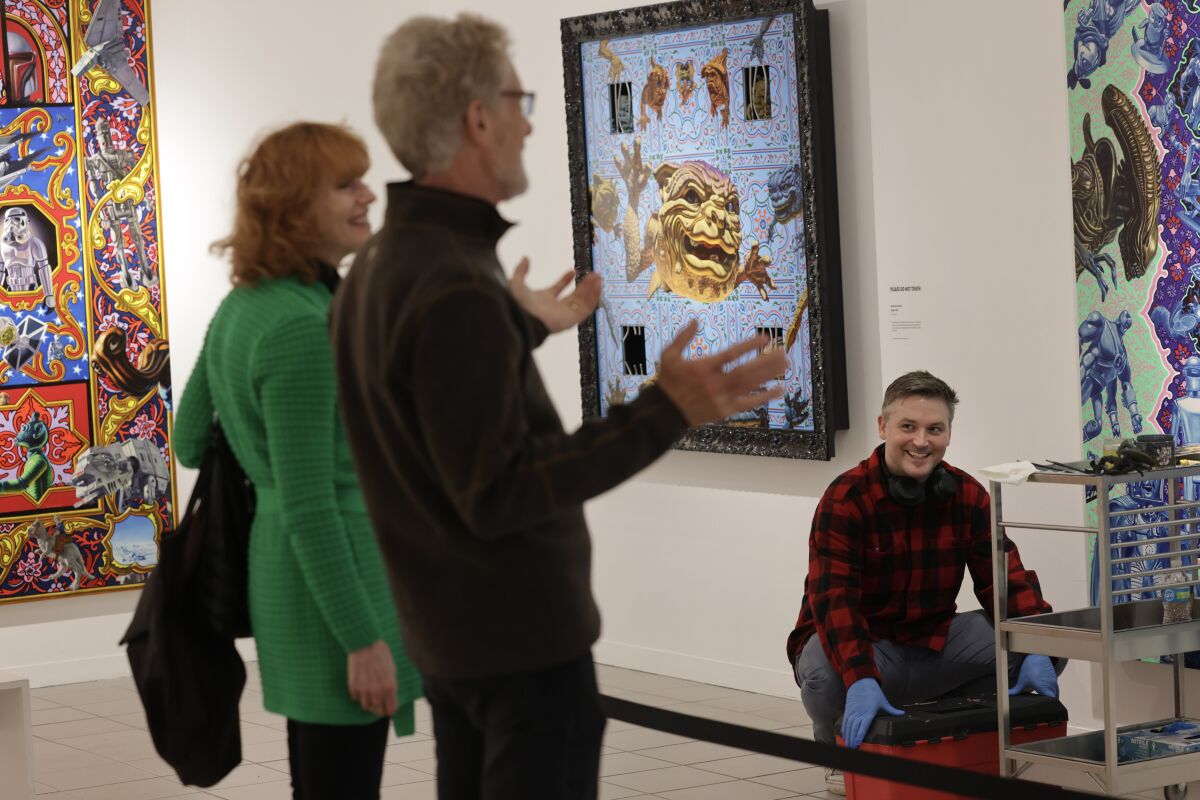 Artist Robert Xavier Burden talks to visitors at the Oceanside Museum of ARt.
