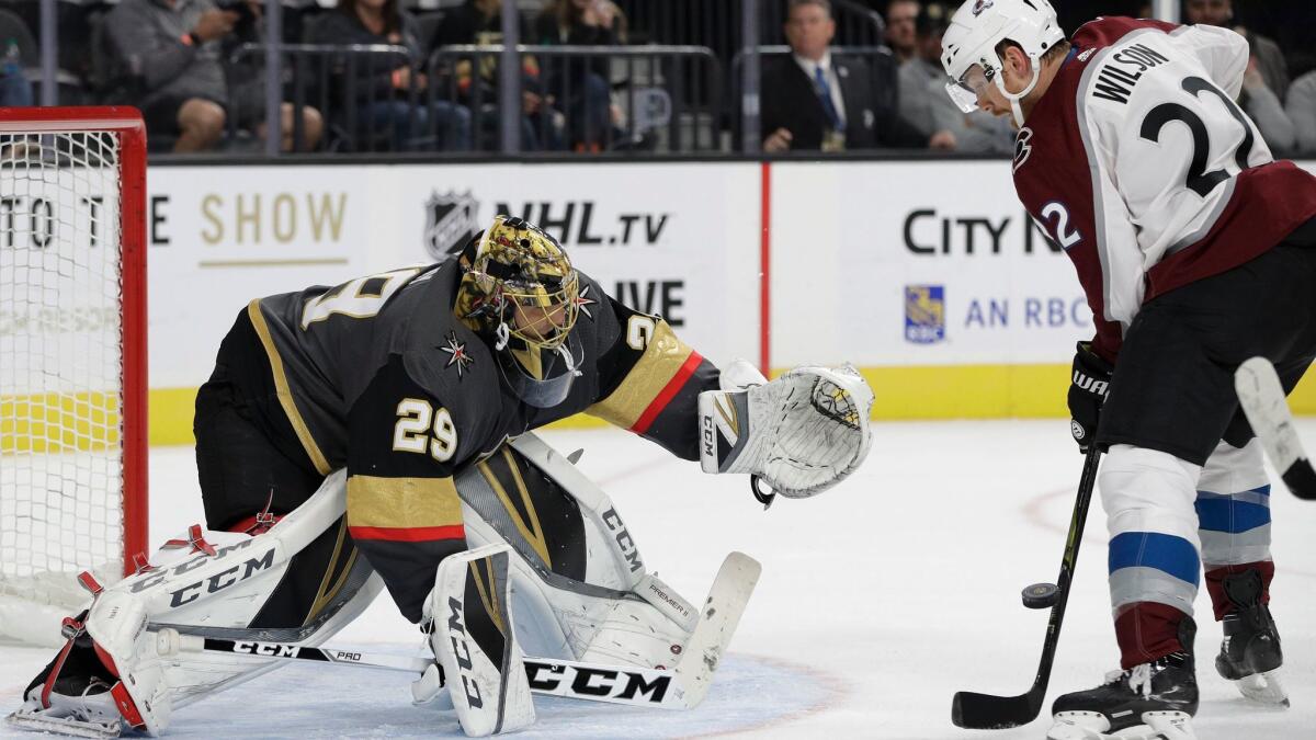 Vegas Golden Knights goalie Marc-Andre Fleury blocks a shot in front of Colorado Avalanche's Colin Wilson during a preseason hockey game on Sept. 28.