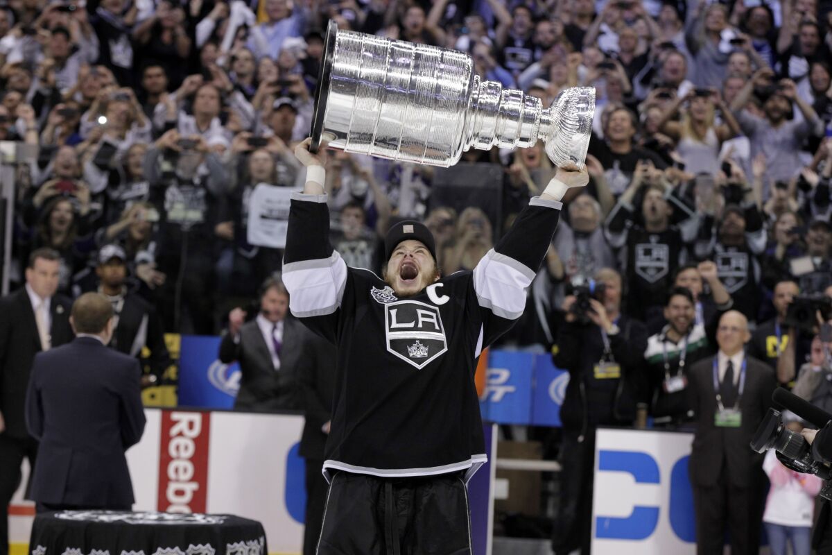 Kings captain Dustin Brown celebrates with the Stanley Cup after the Kings defeated the New Jersey Devils in 2012.