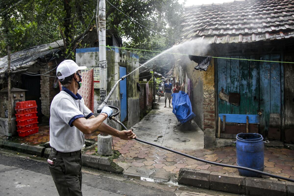 A civic worker disinfects an area in Kolkata, India.