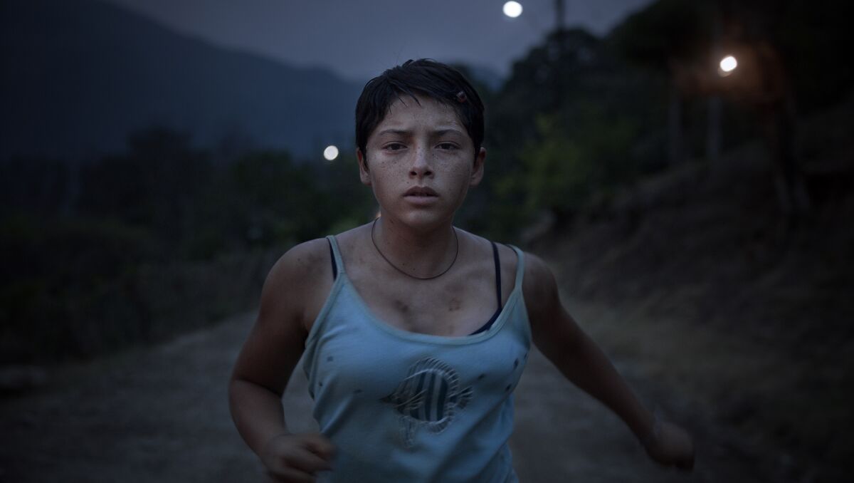 A teenage girl runs in the film “Prayers for the Stolen.”
