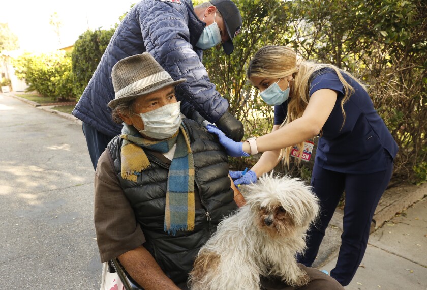 Nurse Bella Pashabezyan administers COVID-19 vaccine to Nelson Navarro in Glendale.