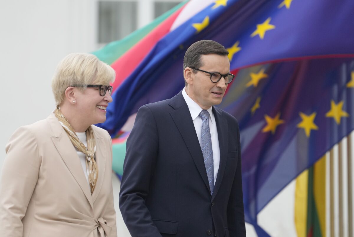 Lithuanian Prime Minister Ingrida Simonyte, left, being greeted by Poland's Prime Minister Mateusz Morawiecki on a visit for talks that include the region's security in the face of migrant pressure on the two countries' borders with Belarus, in Warsaw, Poland, on Friday, Sept. 17, 2021. (AP Photo/Czarek Sokolowski)