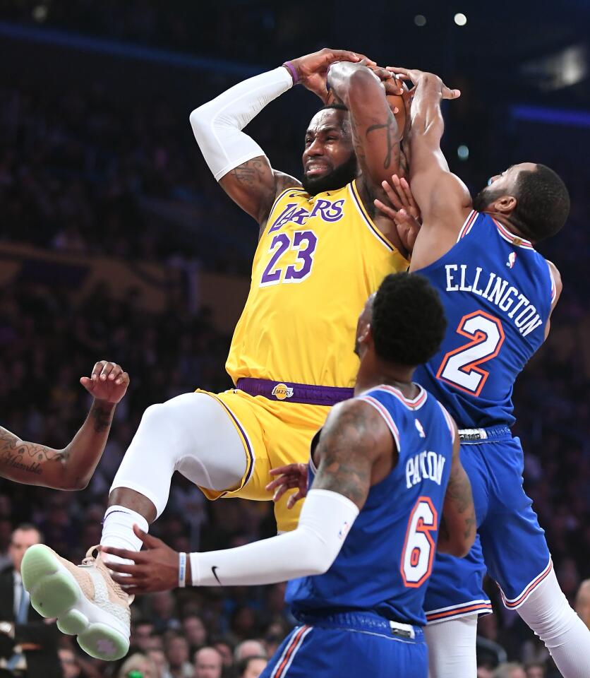 LeBron James is fouled by Knicks guard Wayne Ellington (2) during the first quarter of a game Jan. 7 at Staples Center.
