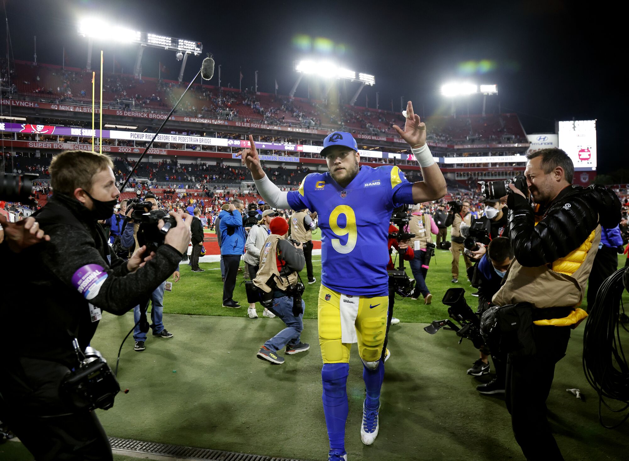 Rams quarterback Matthew Stafford gives the victory sign as he leaves the field after beating the Buccaneers 30-27