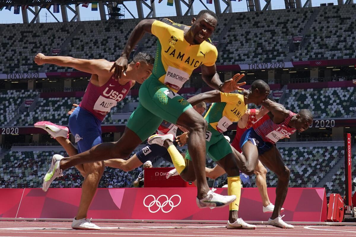 Hansle Parchment of Jamaica wins the men's 110-meter hurdles final ahead of U.S. hurdler Grant Holloway.