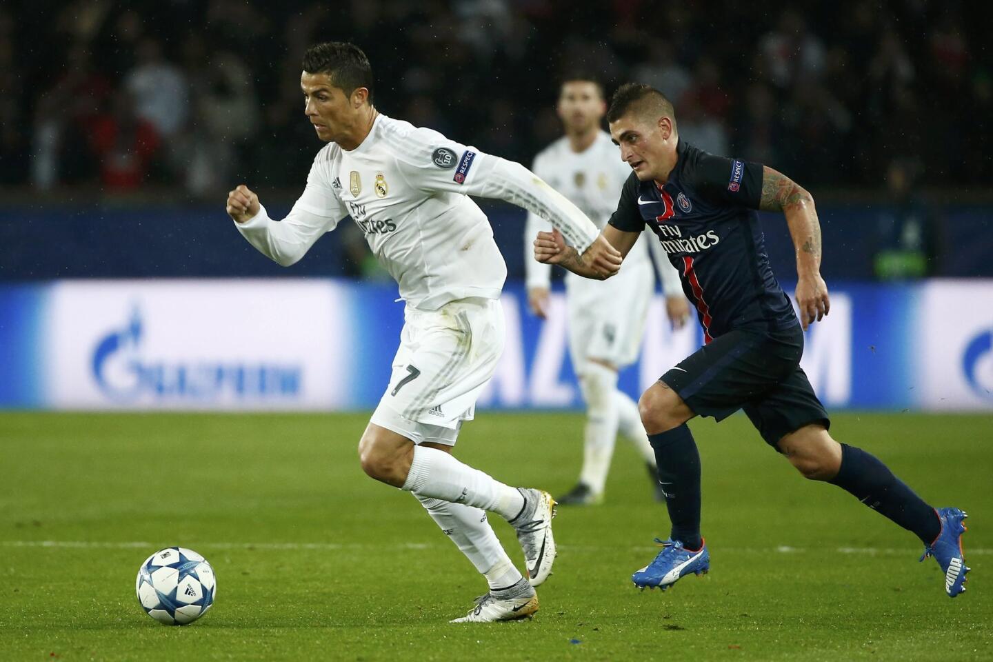 Real Madrid's Cristiano Ronaldo controls the ball against Paris Saint Germain's Marco Verratti during their Champions League Group A soccer match at the Parc des Princes stadium in Paris