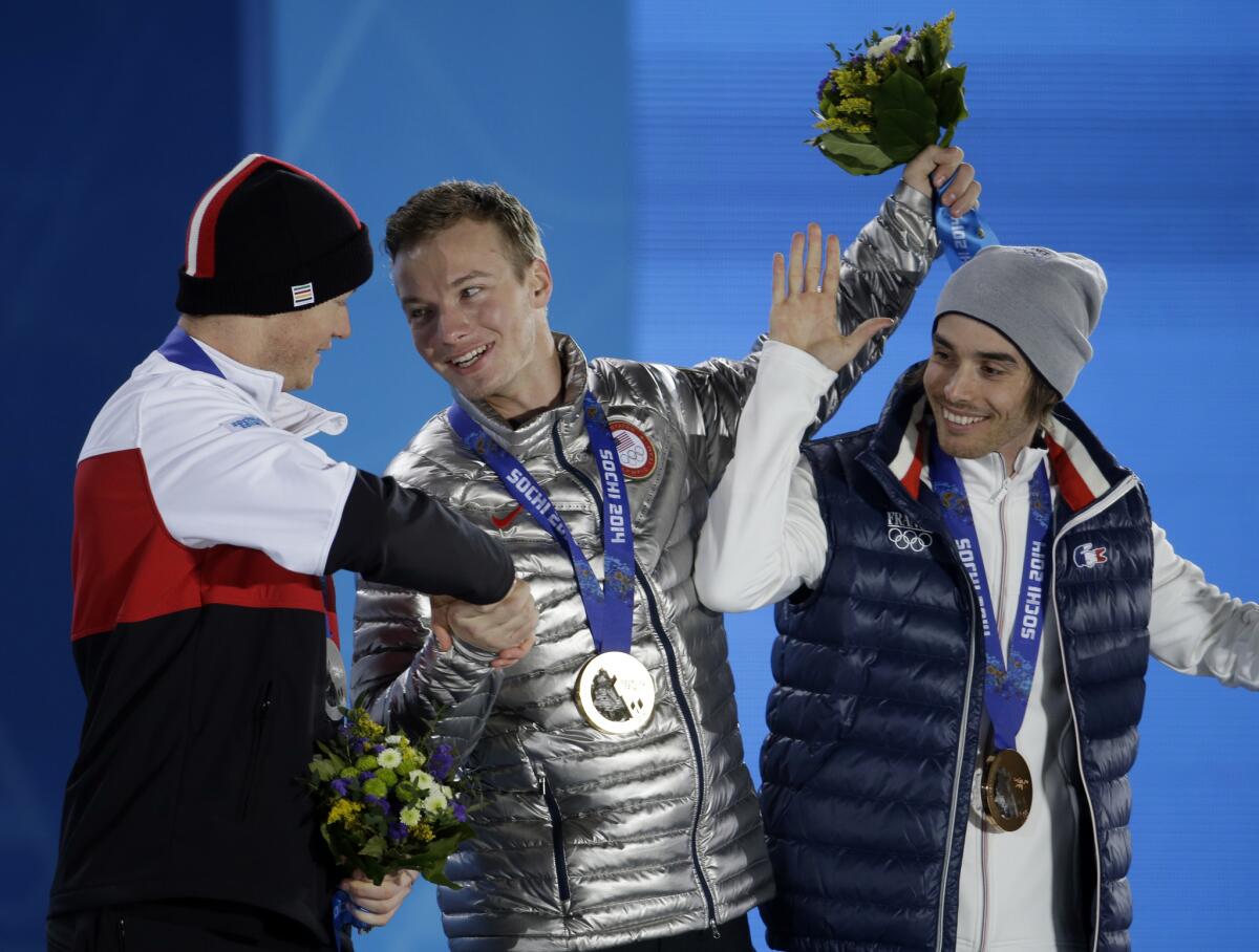 Men's freestyle skiing halfpipe medalists, from left, Mike Riddle of Canada (silver), David Wise of the United States (gold), and Kevin Rolland of France (bronze), congratulate one another during the medalceremony at the 2014 Winter Olympics in Sochi, Russia.