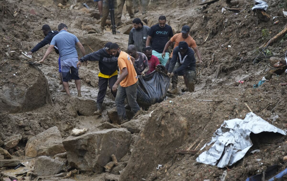 People removing body of a landslide victim