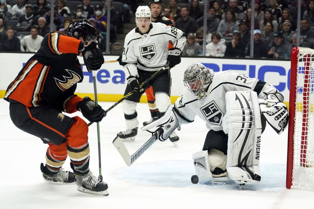Los Angeles Kings goaltender Jonathan Quick, right, stops a shot during the second period of an NHL hockey game against the Anaheim Ducks on Tuesday, April 19, 2022, in Anaheim, Calif. (AP Photo/Marcio Jose Sanchez)