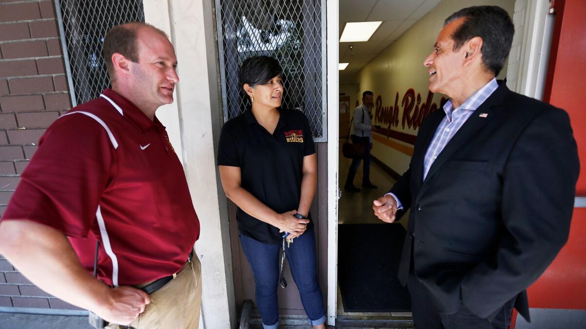 Villaraigosa talks with Roosevelt High School Principal Ben Gertner, left, and staff