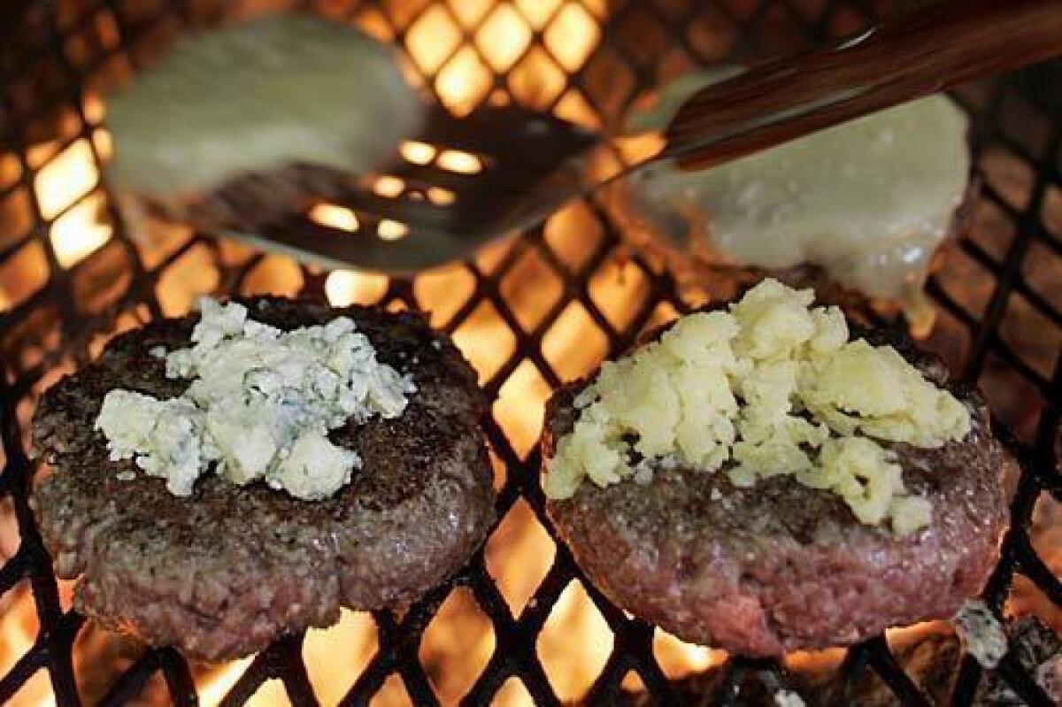 Crumbled blue cheese and cheddar top Nancy's burgers.