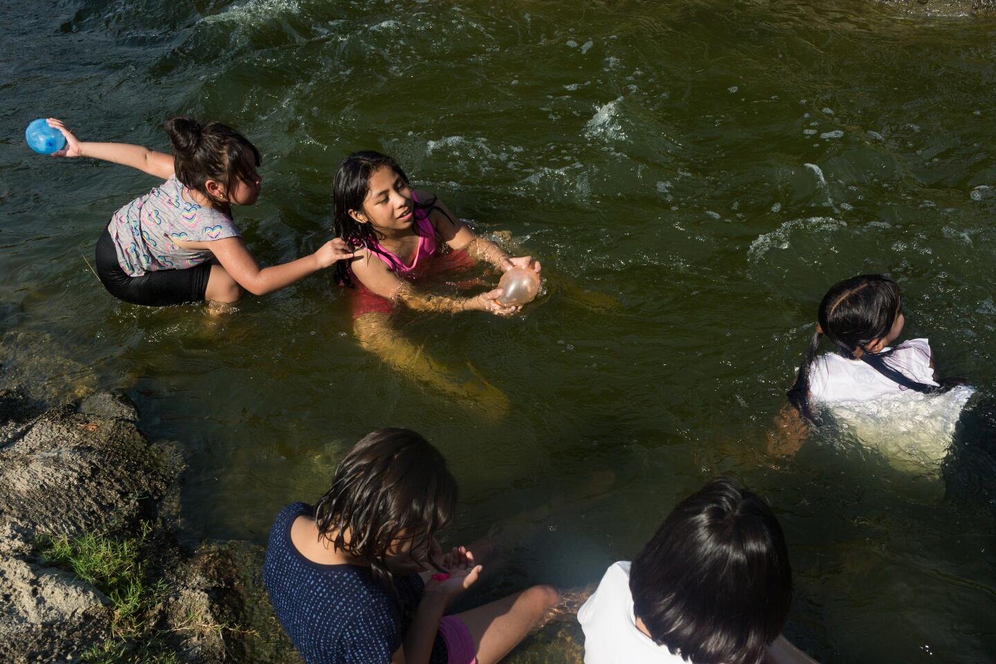Girls play in a stream near Lake Balboa/Anthony C. Beilenson Park on Sunday.