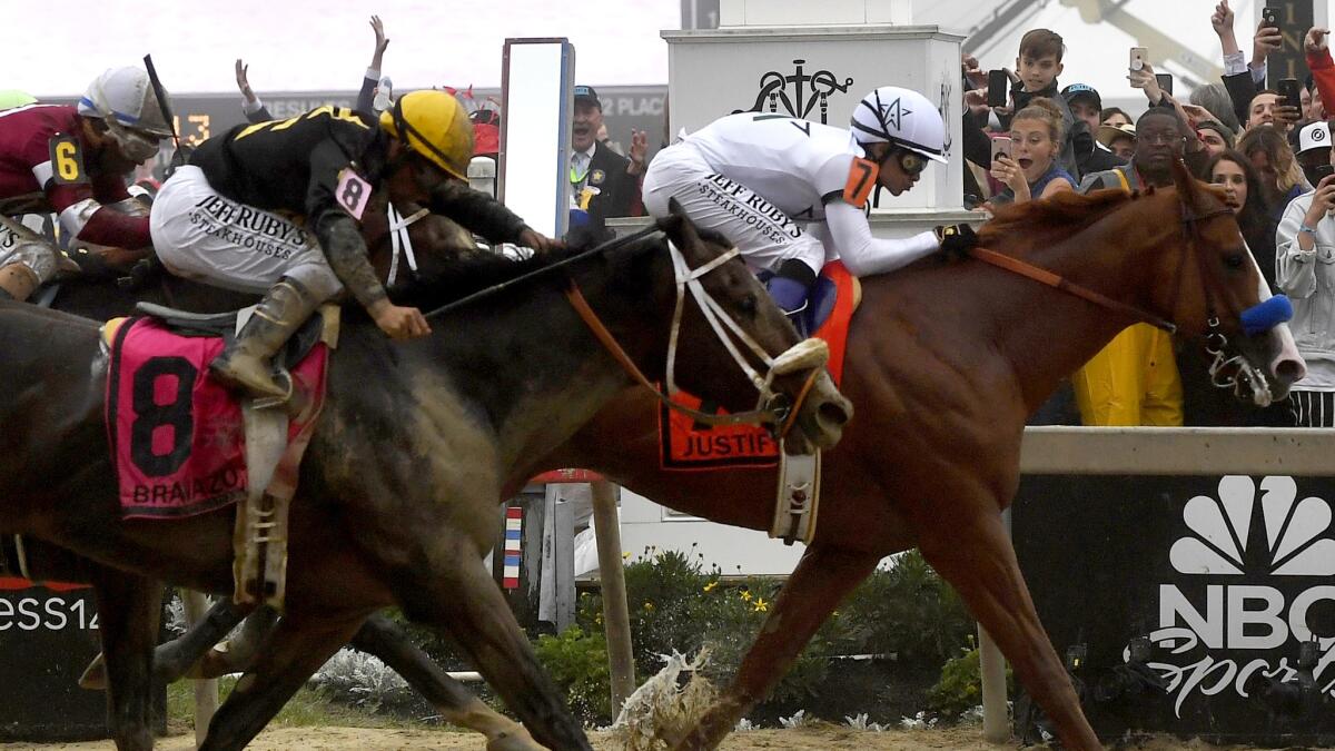 Mike Smith guides Justify to victory in the Preakness Stakes half a length ahead of Bravazzo on Saturday.