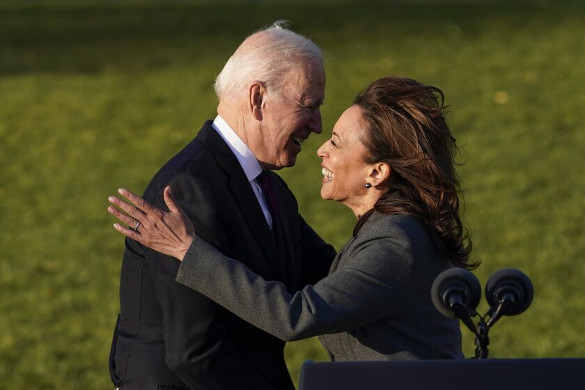 President Joe Biden hugs Vice President Kamala Harris as he speaks before signing the $1.2 trillion bipartisan infrastructure bill into law during a ceremony on the South Lawn of the White House in Washington, Monday, Nov. 15, 2021. (AP Photo/Susan Walsh)