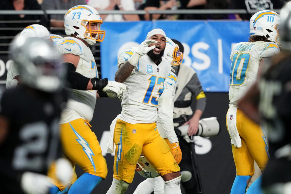 The Chargers' Keenan Allen (13) makes a talking gesture with his hand after making a touchdown catch against the Raiders.