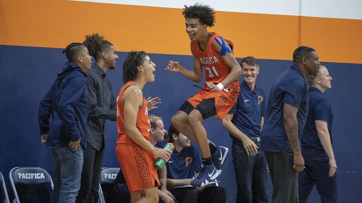 Pacifica Christian Orange County High's Houston Mallette (31) reacts after teammate Michael Salerno hit a jumper during a season opener against visiting Silverado St. Michael's Prep on Tuesday.