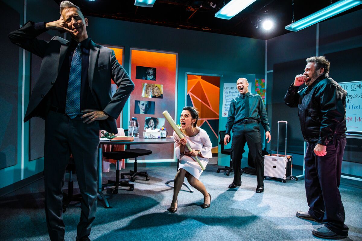 A woman screams in an office place while three men laugh at her