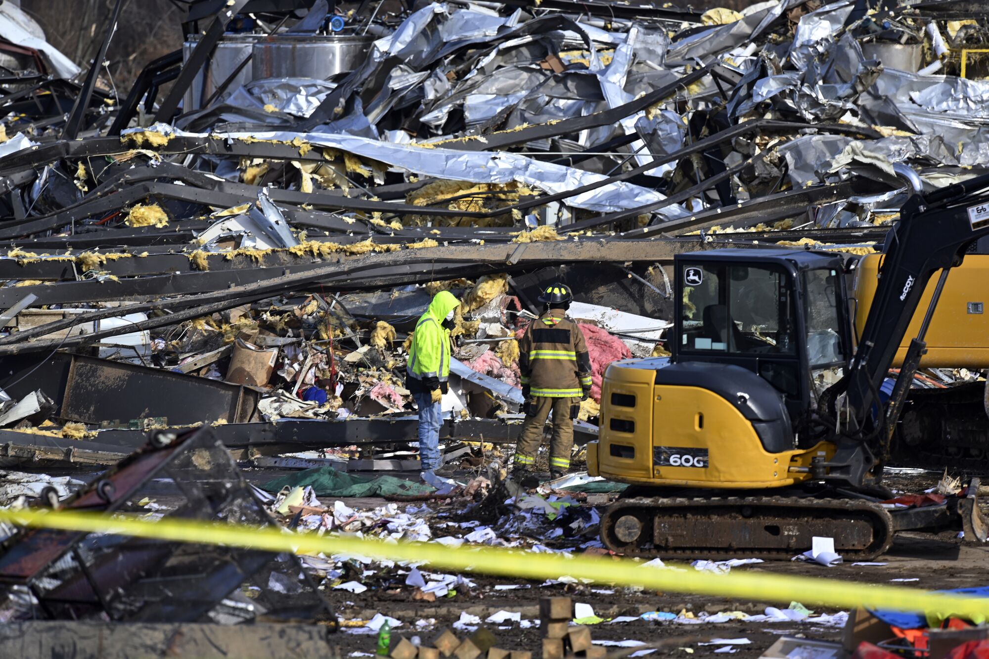 Emergency workers dig through the rubble of a factory.