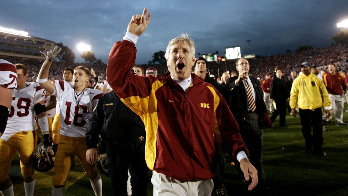 Then-USC coach Pete Carroll celebrates after the Trojans defeated UCLA 29-24 at the Rose Bowl on Dec. 4, 2004.