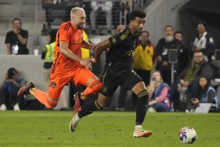 Los Angeles FC midfielder Timothy Tillman, right, gets entangled with Houston Dynamo midfielder Héctor Herrera during the second half in the MLS playoff Western Conference final soccer match Saturday, Dec. 2, 2023, in Los Angeles. (AP Photo/Marcio Jose Sanchez)