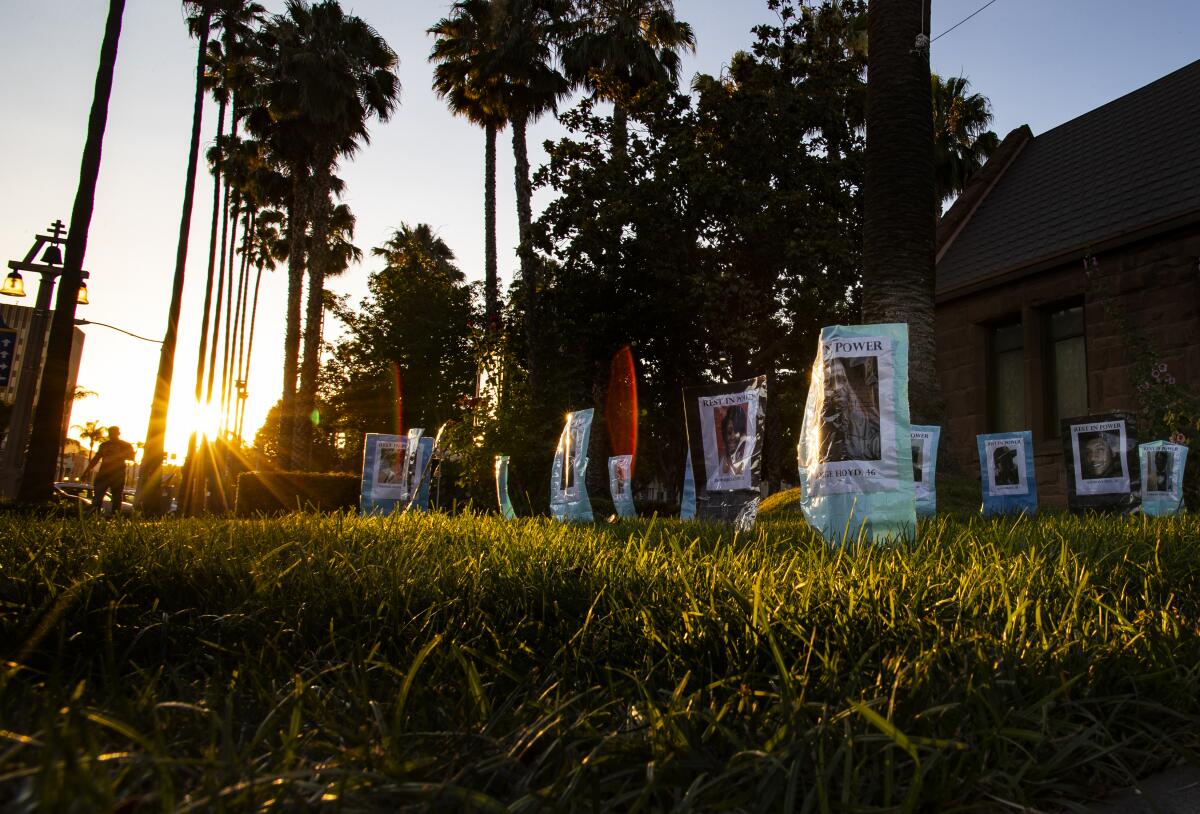 Photographs are set up at the Universalist Unitarian Church of Riverside of Black people killed by police.