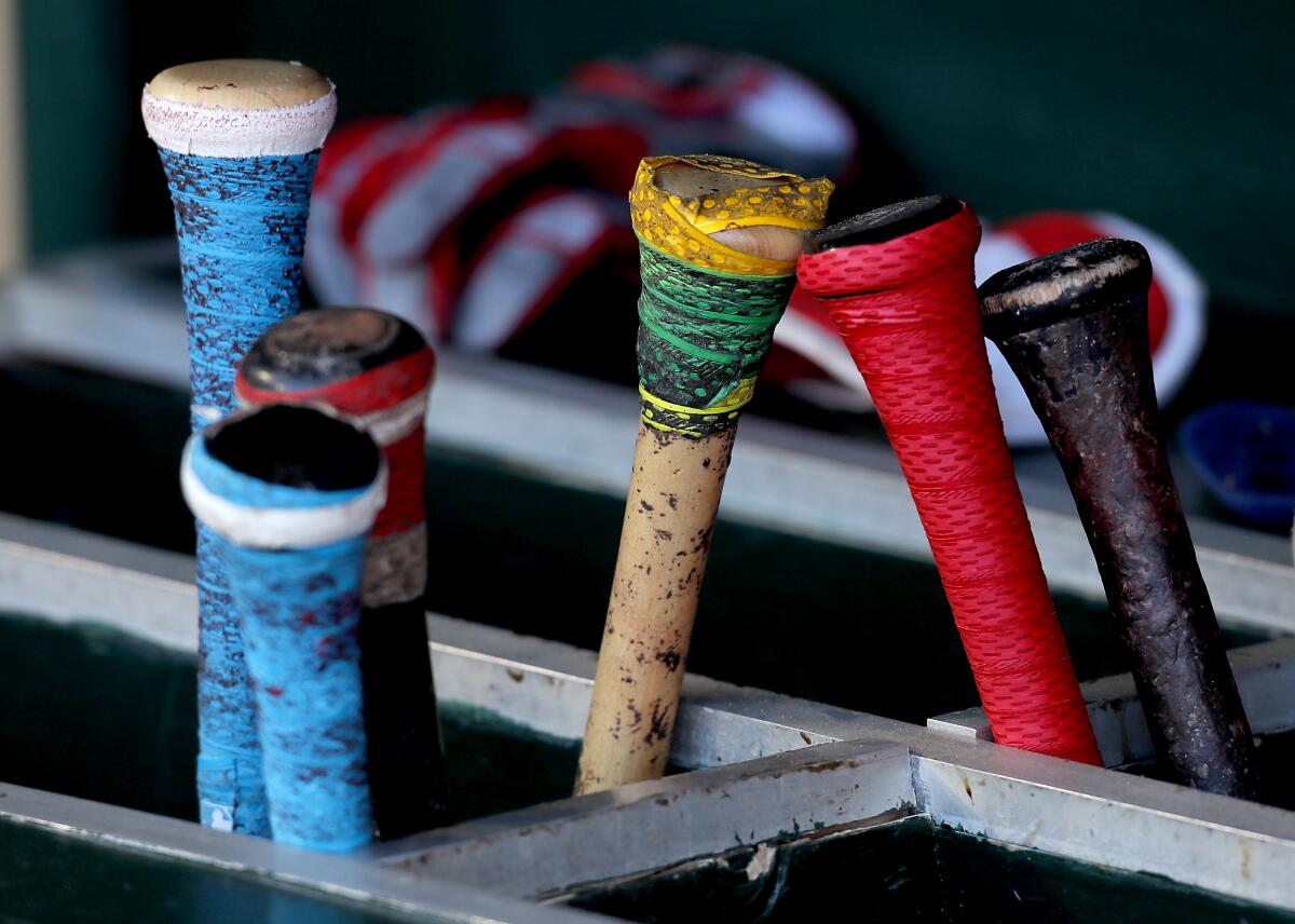 Bats stand in a rack.