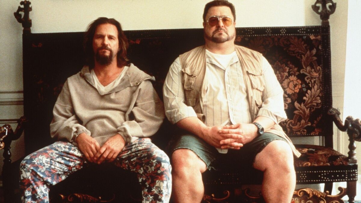 Jeff Bridges and John Goodman sit next to each other in the film "The Big Lebowski."