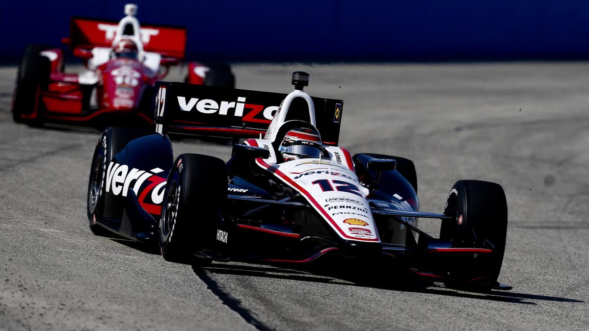 Will Power runs ahead of Tony Kanaan in the early stages of Sunday's IndyCar Series race the Milwaukee Mile.